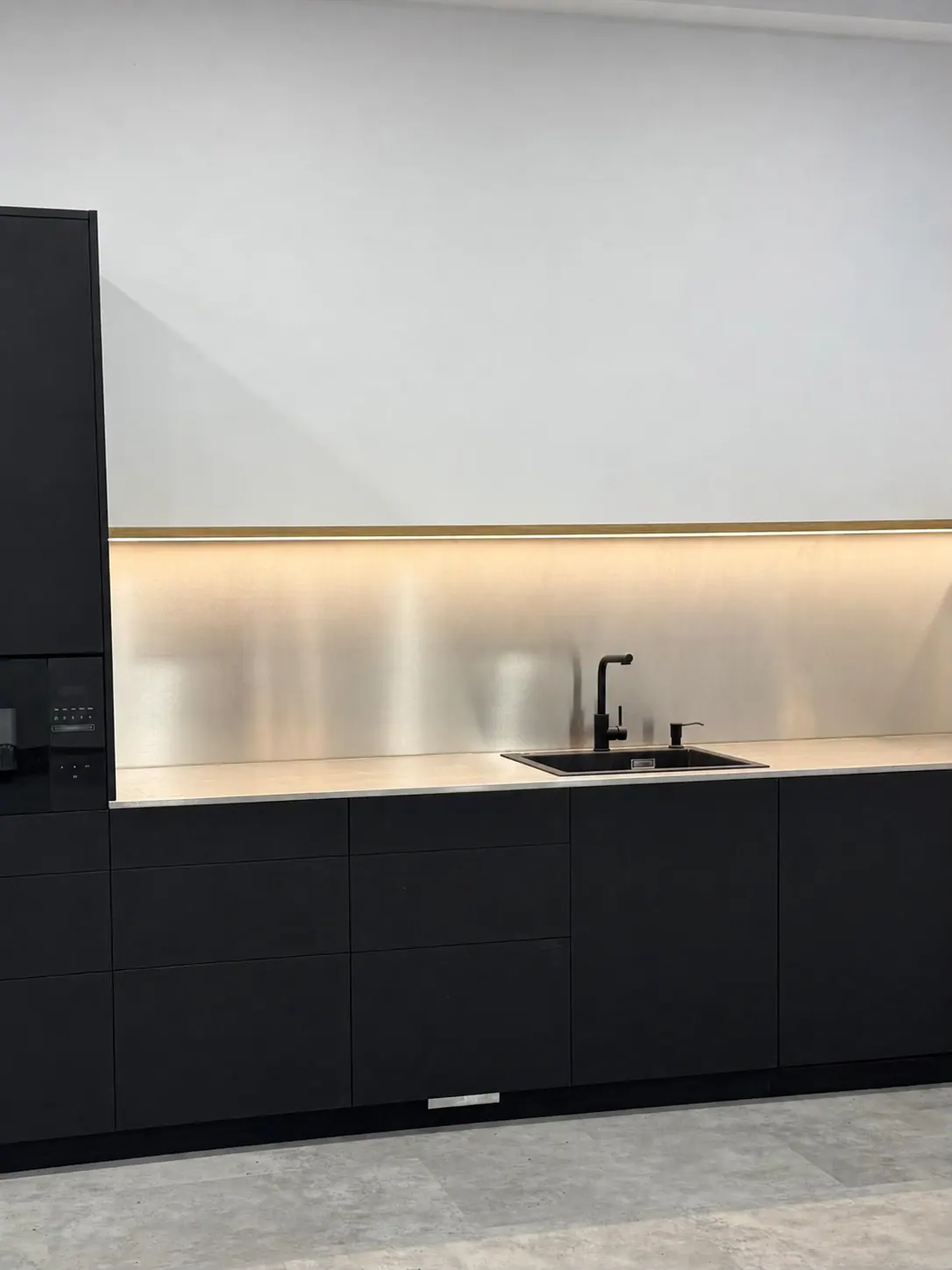 Cocina a medida en tonos oscuros con encimera iluminada